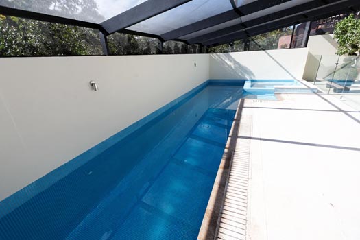 Almond Granite Paving & Almond Granite Grate & Sky Blue Pearl Fully Tiling stone tile or pool paver shown in situ with matching coping