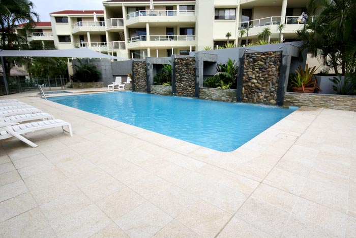 Almond Granite stone tile or pool paver shown in situ with matching coping