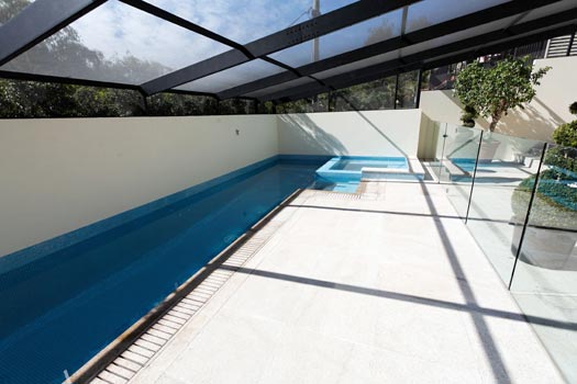 Almond Granite Paving & Almond Granite Grate & Sky Blue Pearl Fully Tiling stone tile or pool paver shown in situ with matching coping