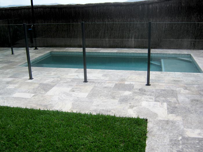 Silver Travertine Tumbled Unfilled stone tile or pool paver shown in situ with matching coping