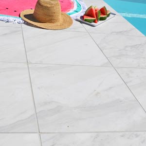 Carrara Marblano tiles shown around a pool