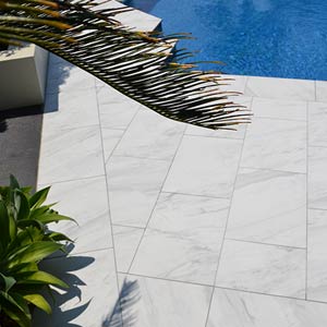 Carrara Marblano tiles shown around a pool