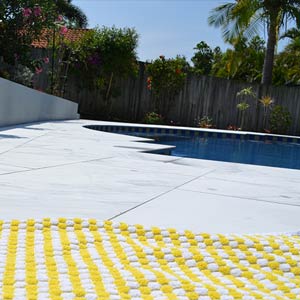 Carrara Marblano tiles shown around a pool