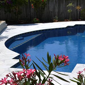 Carrara Marblano tiles shown around a pool