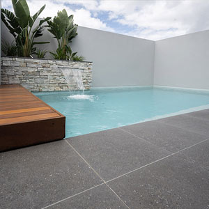 Meteor Granito tiles shown around a pool