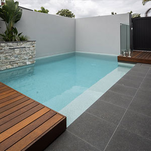 Meteor Granito tiles shown around a pool