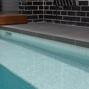 Meteor Granito tiles shown around a pool