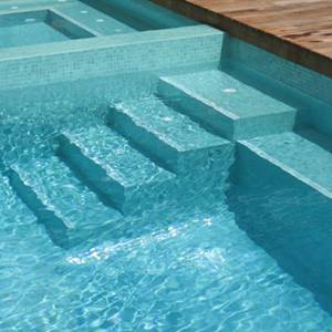 GC093 Aquamarine Pearl glass mosaic pool tiles shown tiling a pool interior walls and bottom
