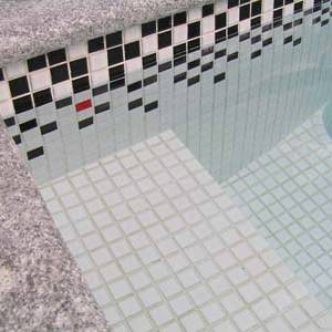 White Black Tide ceramic mosaic pool tiles shown as waterline tiles