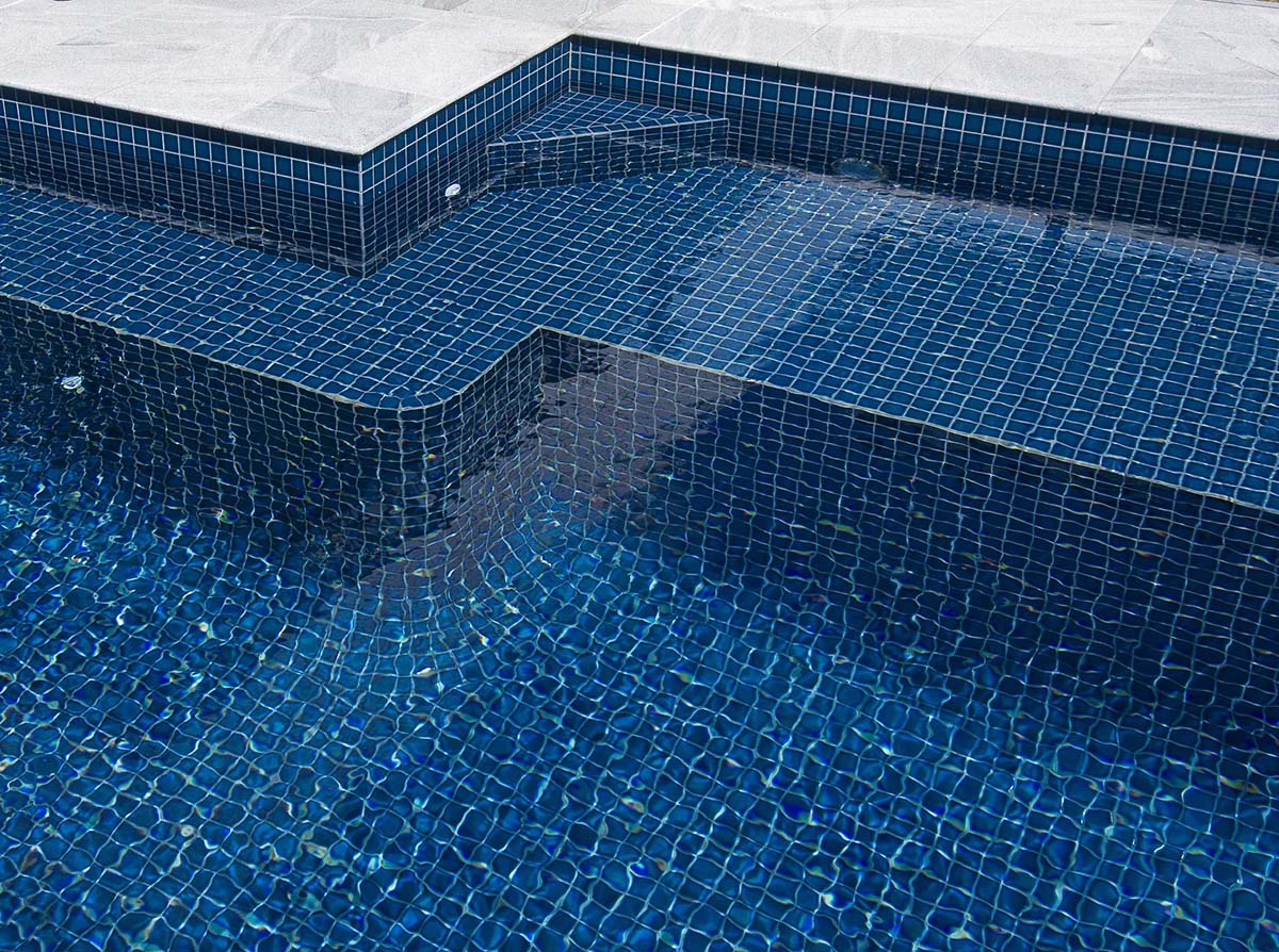CMC098 Ocean Blue full-tiled pool with Sandwave Granite coping and surrounds