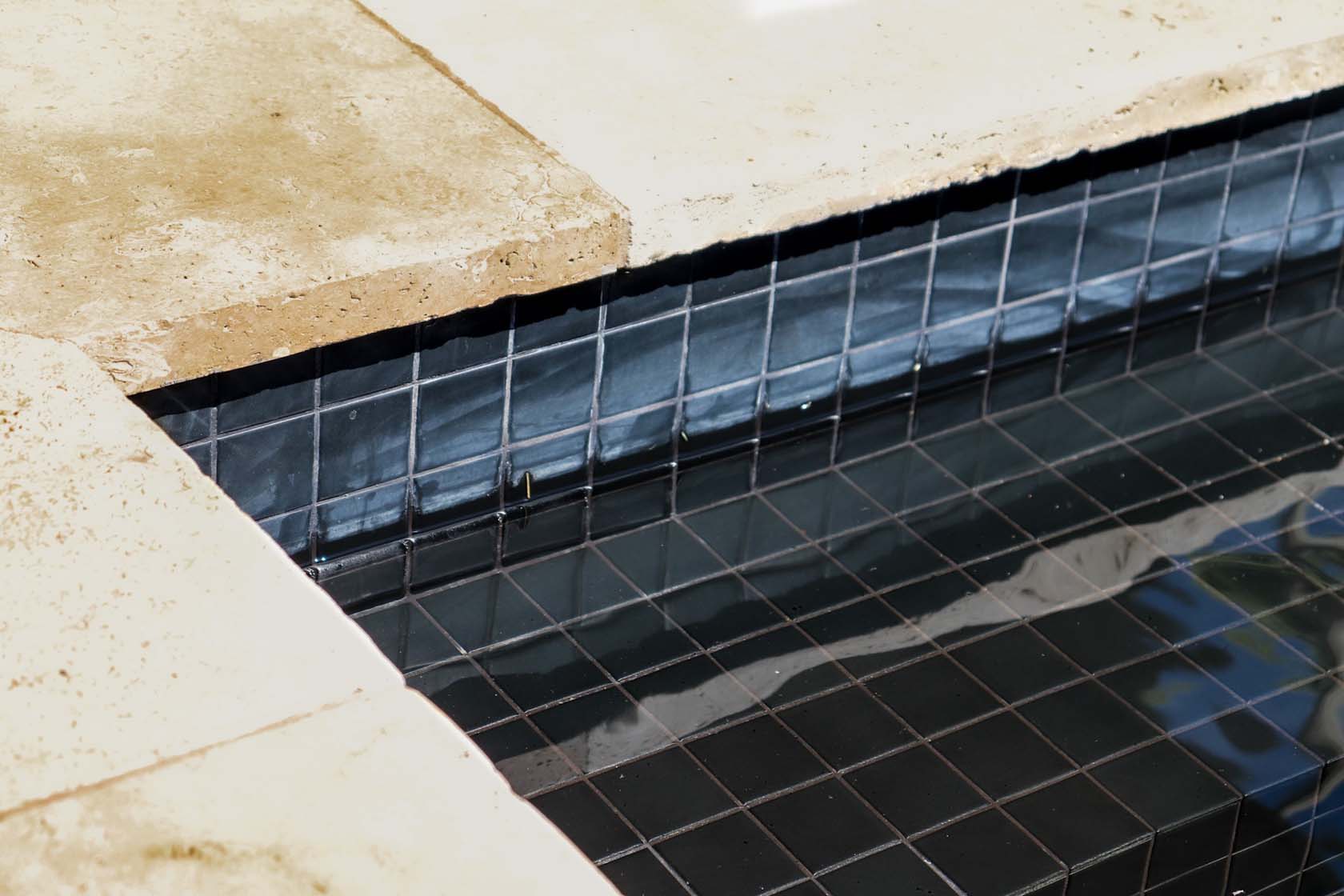 CMC122 Matt Black fully tiled pool with Travertine