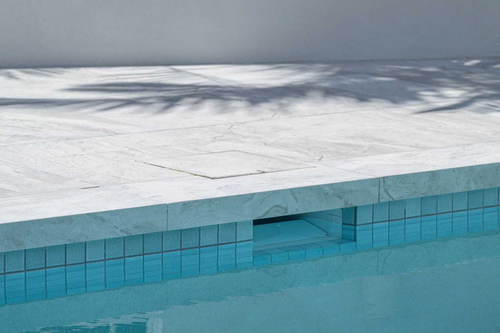 CMC430 Origami Ice Blue waterline tiles with Ash Marblano Dropface pool coping
