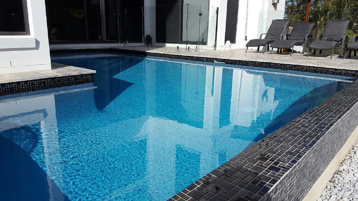 CMC475 Urban Black waterline with Silver Travertine pool coping and surrounds