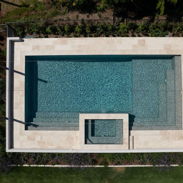 Linen Travertine is natural and organic and creates a calming space, paired with CMC530 Patagonia, a textured ark zinc-grey and light zinc-grey ceramic mosaic creating an aqua coloured water when fully tiled.