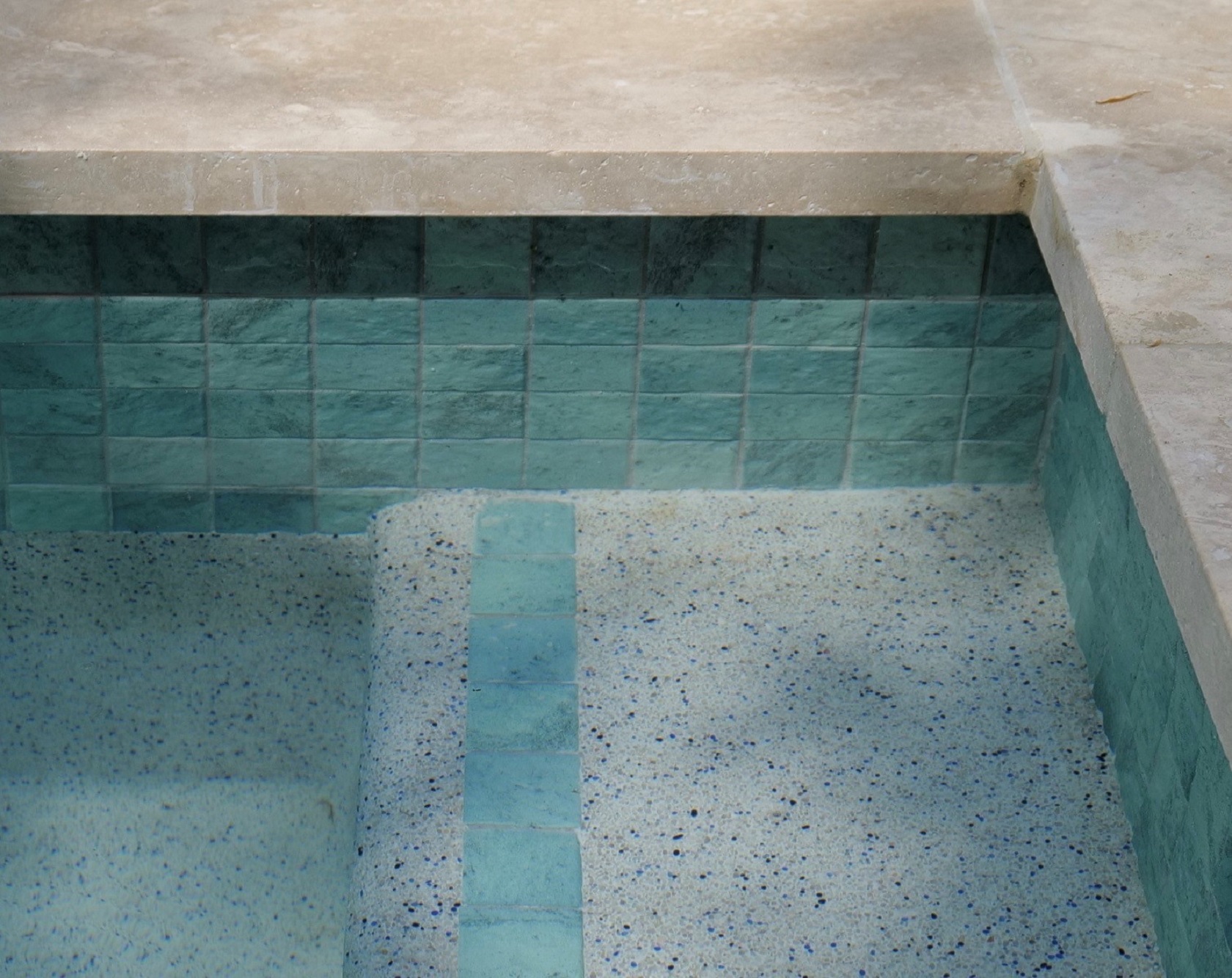 Blue Wave CMC535 waterline and step edge with Travertine coping