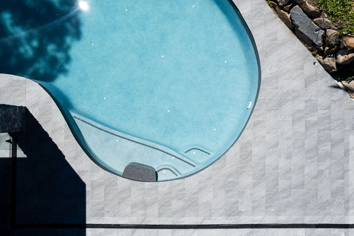 Cosmos Granito pool coping and surrounds with Graphite CMC590 waterline tiles