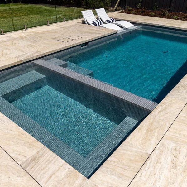CMC655 Druid Grey KitKat Fully-Tiled Pool and Spa + Coastal Cream Travertino Dropface coping and surrounds.