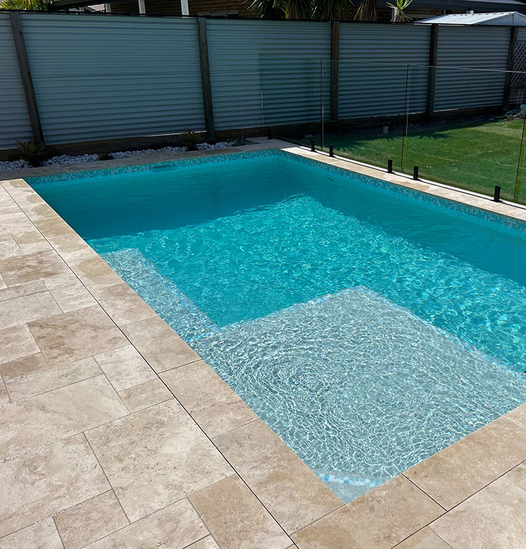 Linen Travertine coping and surrounds for this large pool area, achieving an organic, warm and natural look.