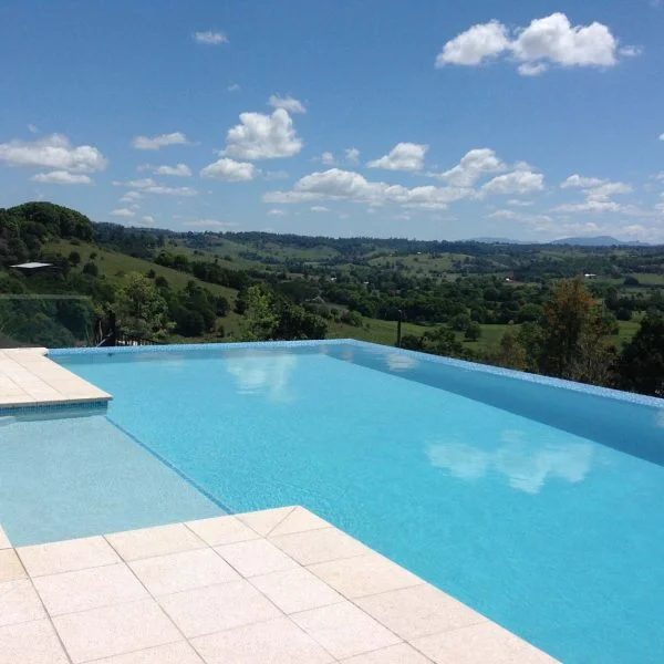 Almond Granite poolside pavers and Rebated Square Edge coping with CMC360 Bering Sea mosaic pool tiles