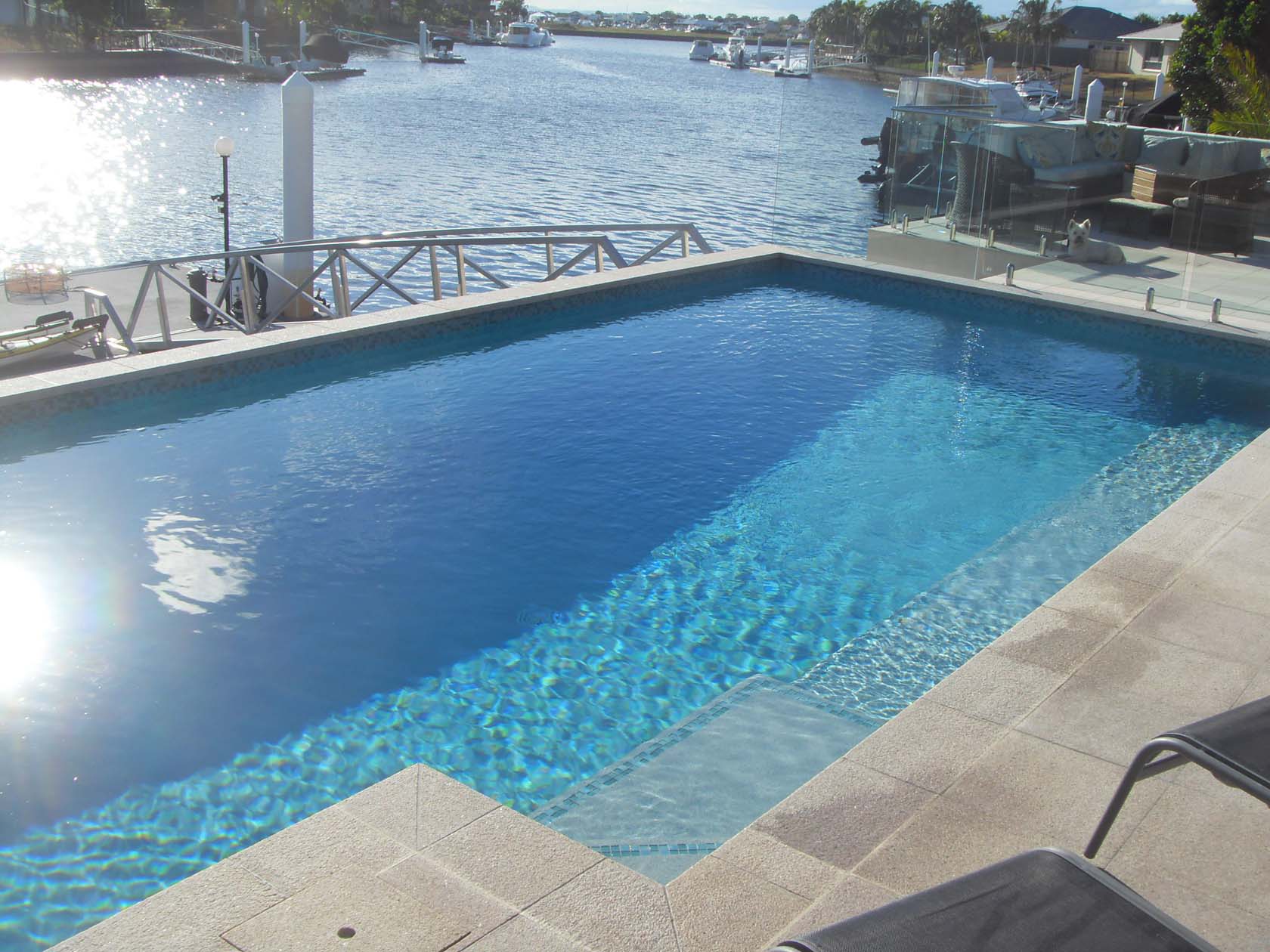 Mushroom Granite natural stone pool coping and surrounds with GCR325 Aqua Crystal Pearl Blend waterline tiles