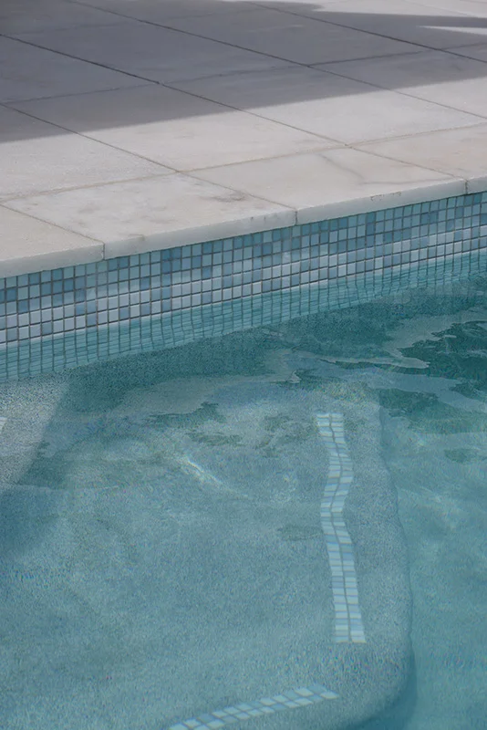 Havana White Marble square edge coping and surrounds & GC420 Alpine glass mosaic waterline and step marker