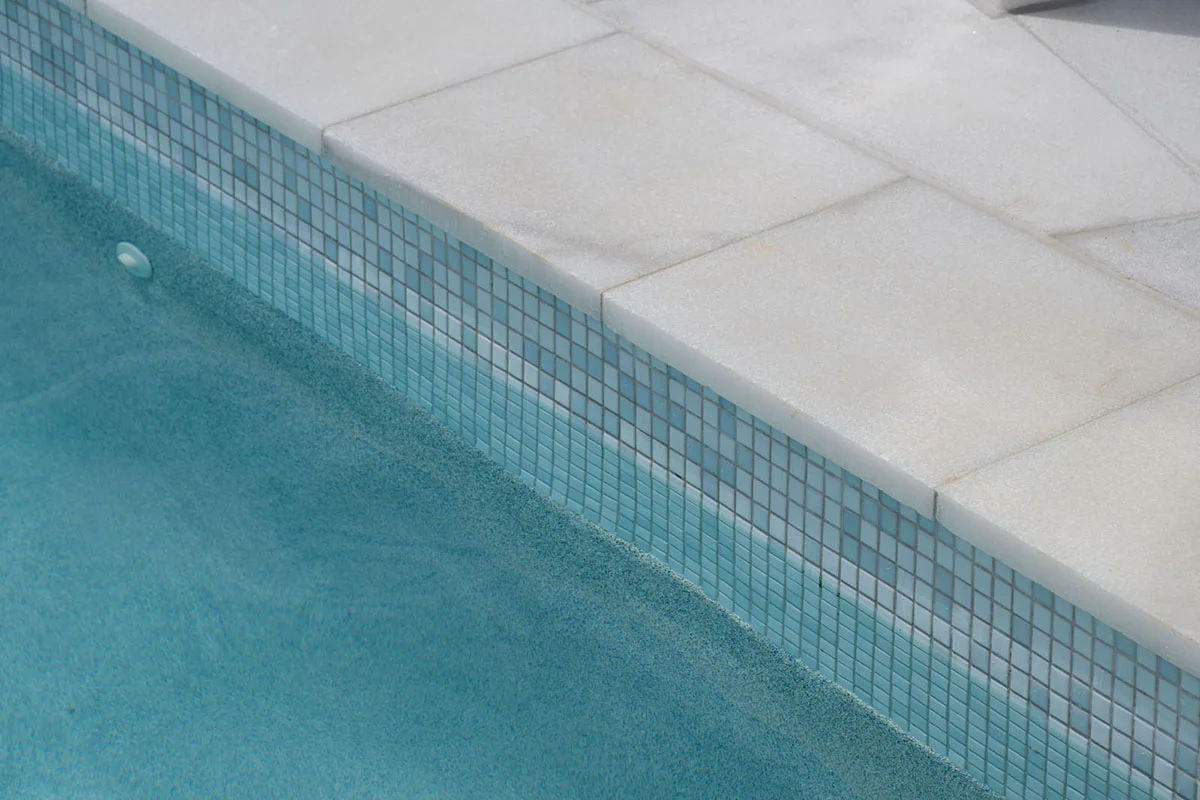 Havana White Marble square edge coping and surrounds & GC420 Alpine glass mosaic waterline and step marker
