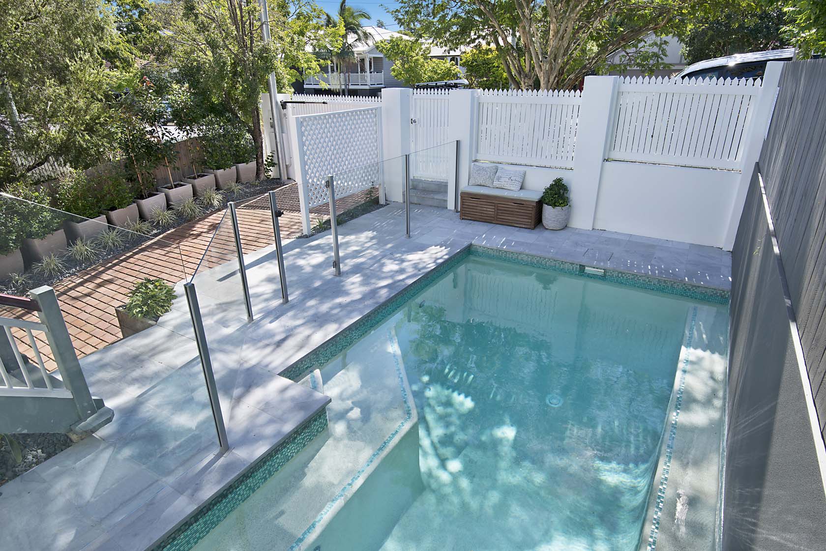 Parisian Blue Limestone pool coping and surrounds with Aqua Crystal Blend waterline tiles