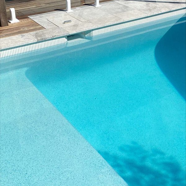 Arctic Dawn square edge coping + Frost White KitKat ceramic mosaic waterline tile