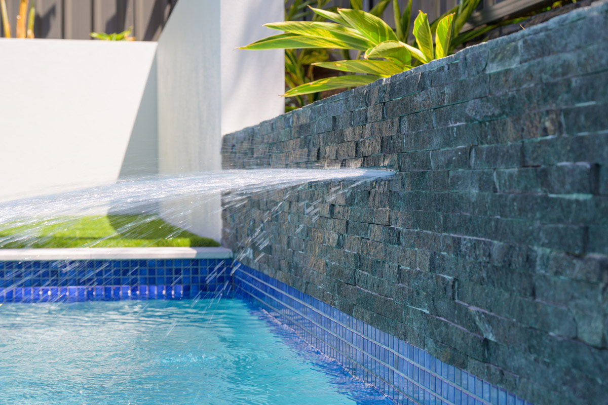 Black stack stone walling achieving a sophisticated and elegant feature to your pool area.