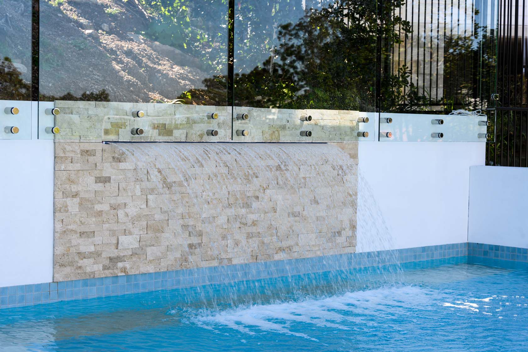SS700 Linen travertine stacked stone feature wall with Origami Ice Blue mosaic pool tiles