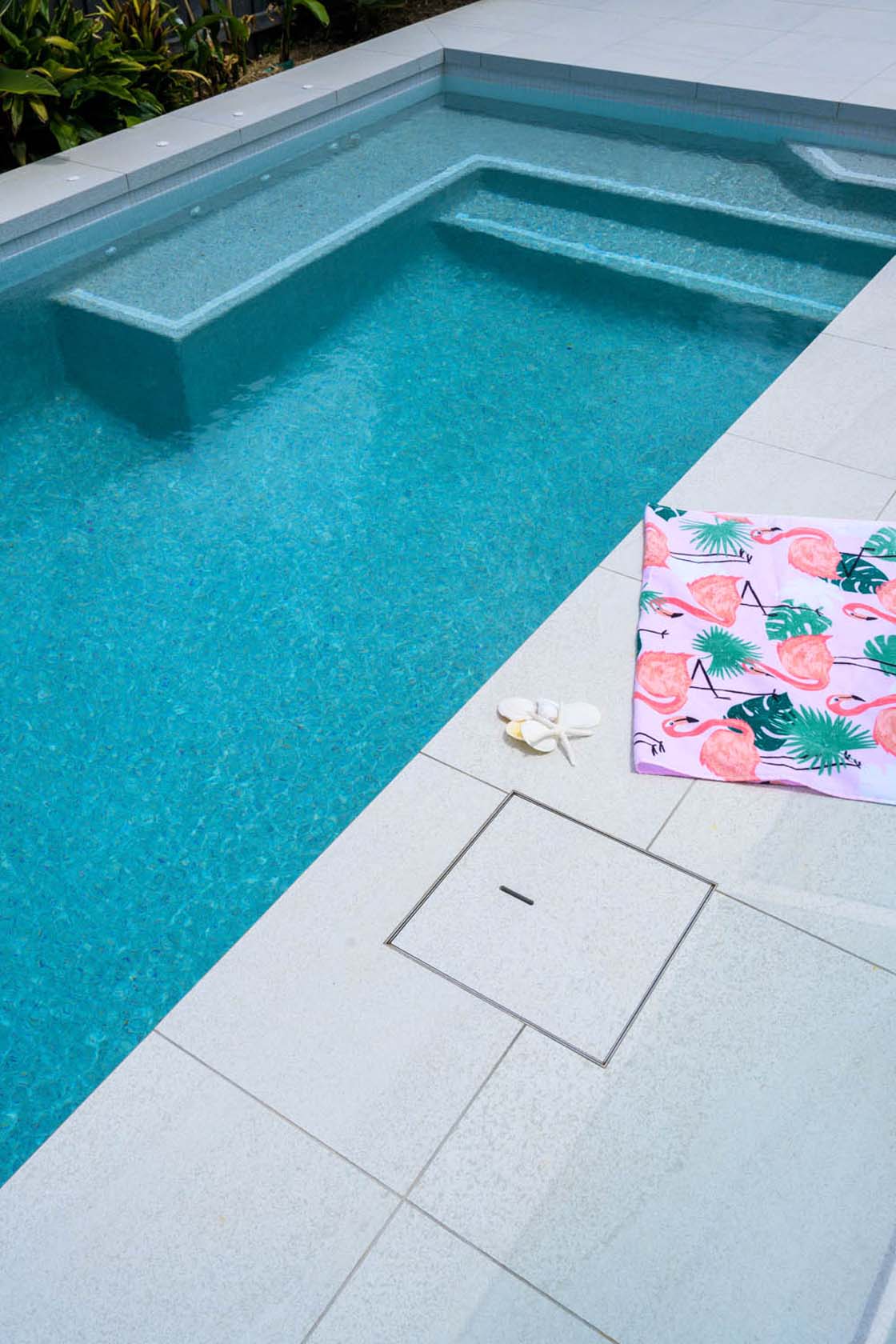 Coconut Drift Porcelain Dropface pool coping and surrounds with Urban White ceramic waterline tiles