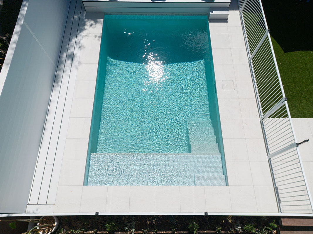 Coconut Drift Porcelain with dropface coping and surrounds achieves a bright, cool and luxe look to any pool area.
