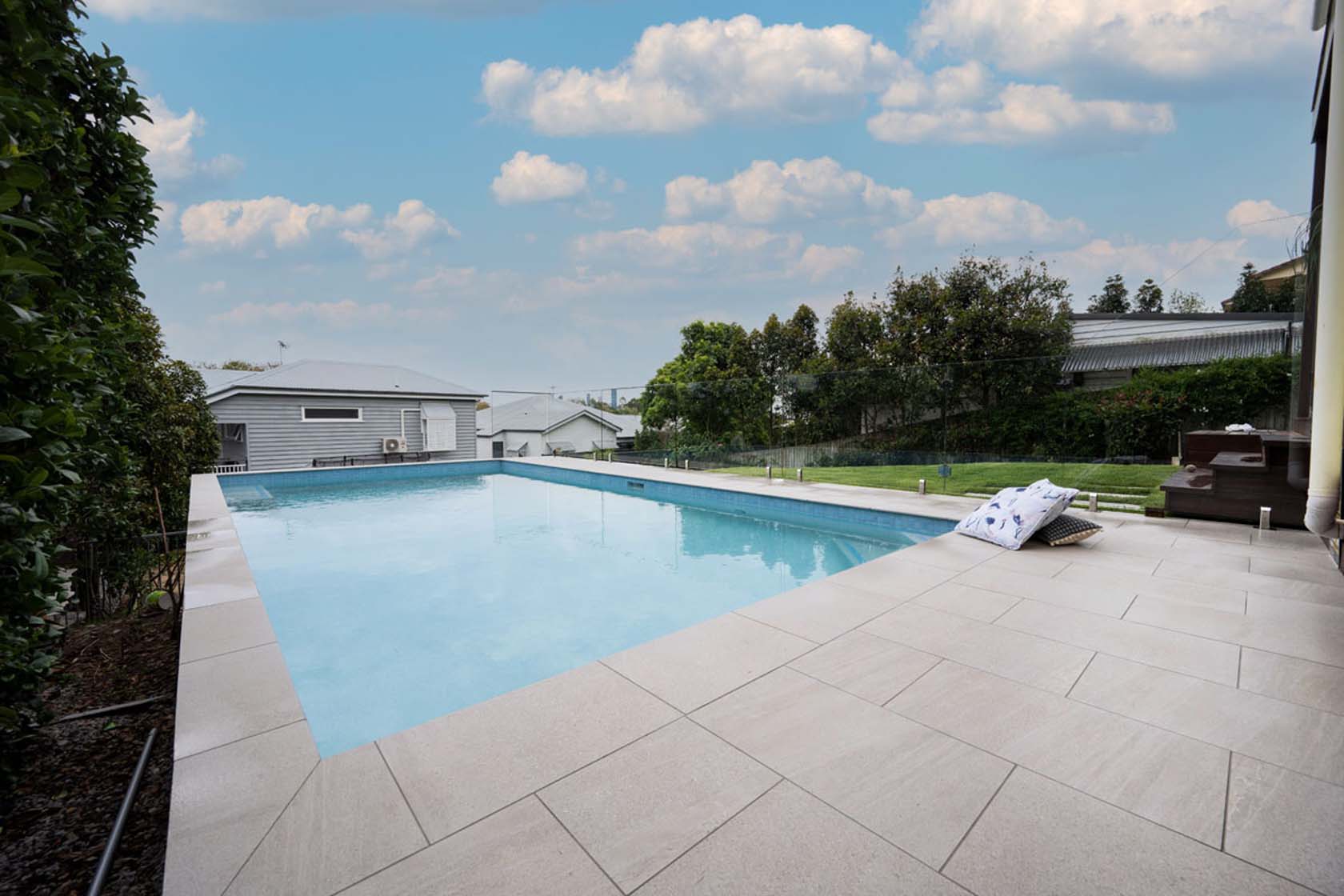 Mercury Porcelain pool coping and surrounds with Currumbin Ceramic waterline and step marker tiles