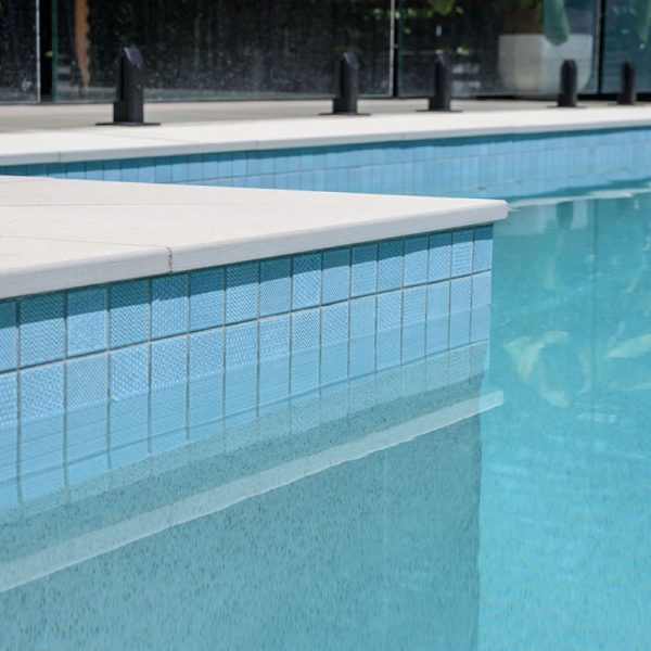 Pluto Porcelain square edge coping + Origami Ice Blue waterline