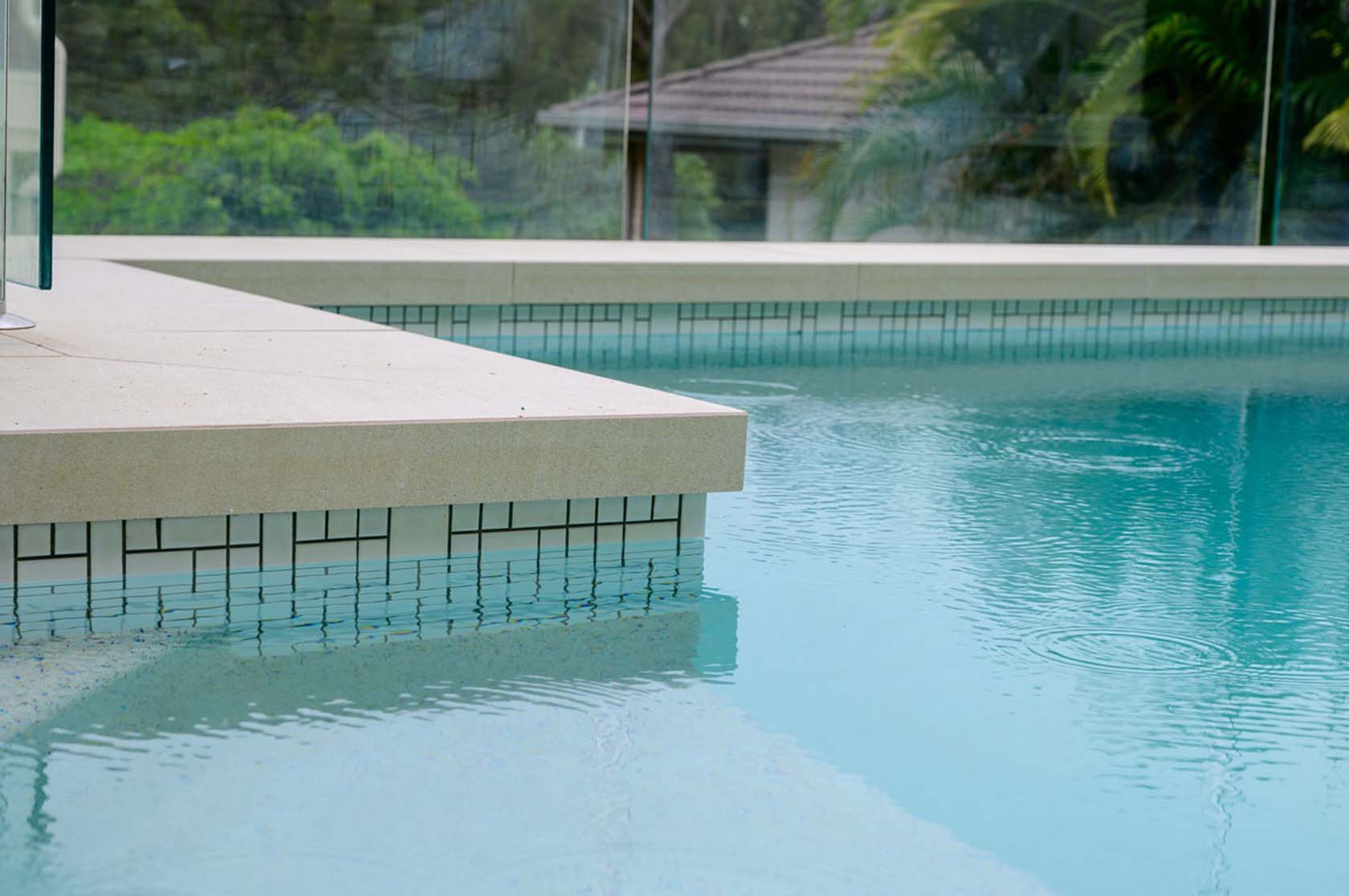 Pluto Porcelain Dropface pool coping with Urban White ceramic waterline tiles