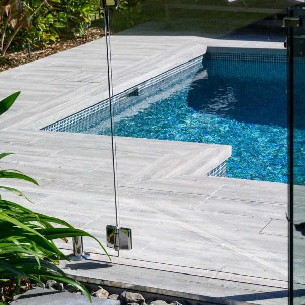 Dark Elm TileDeck Dropface coping and surrounds with fully tiled pool in Peacock glass