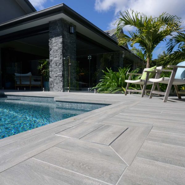 Dark Elm TileDeck Dropface coping and surrounds with fully tiled pool in Peacock glass
