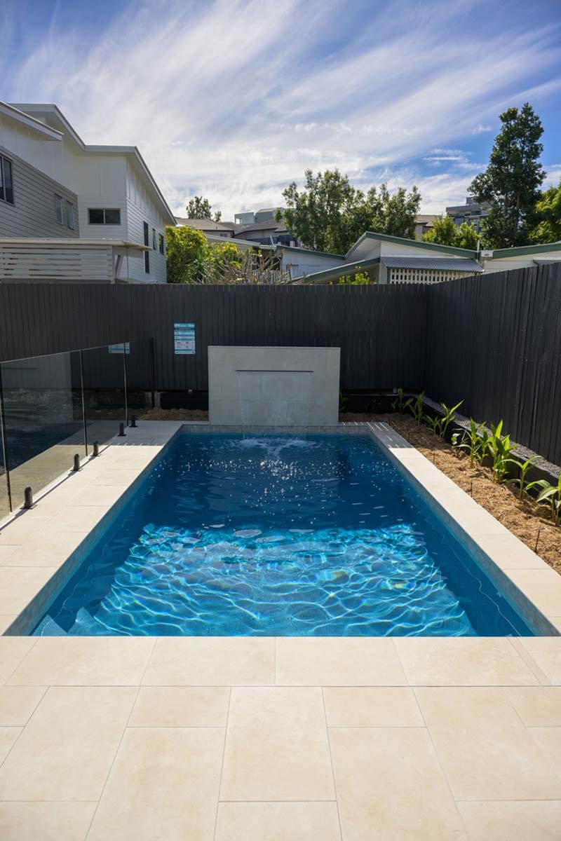 Flax Travertino - 20mm 4 Overhead profile of beige porcelain pool tiles with soft tones and natural sunlight.