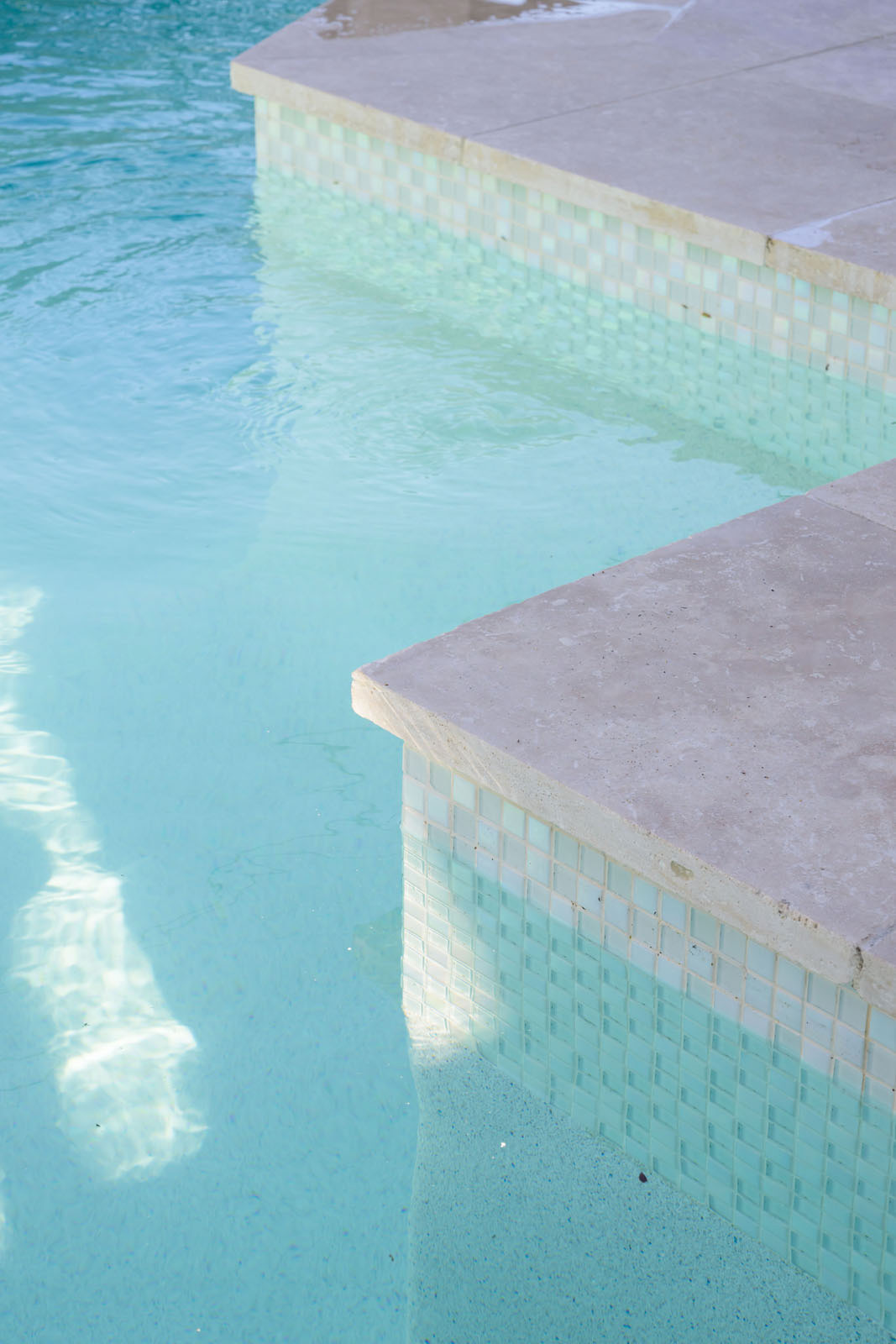 Linen Travertine pool coping and surrounds with White Crystal Pearl Blend GCR305 waterline tile