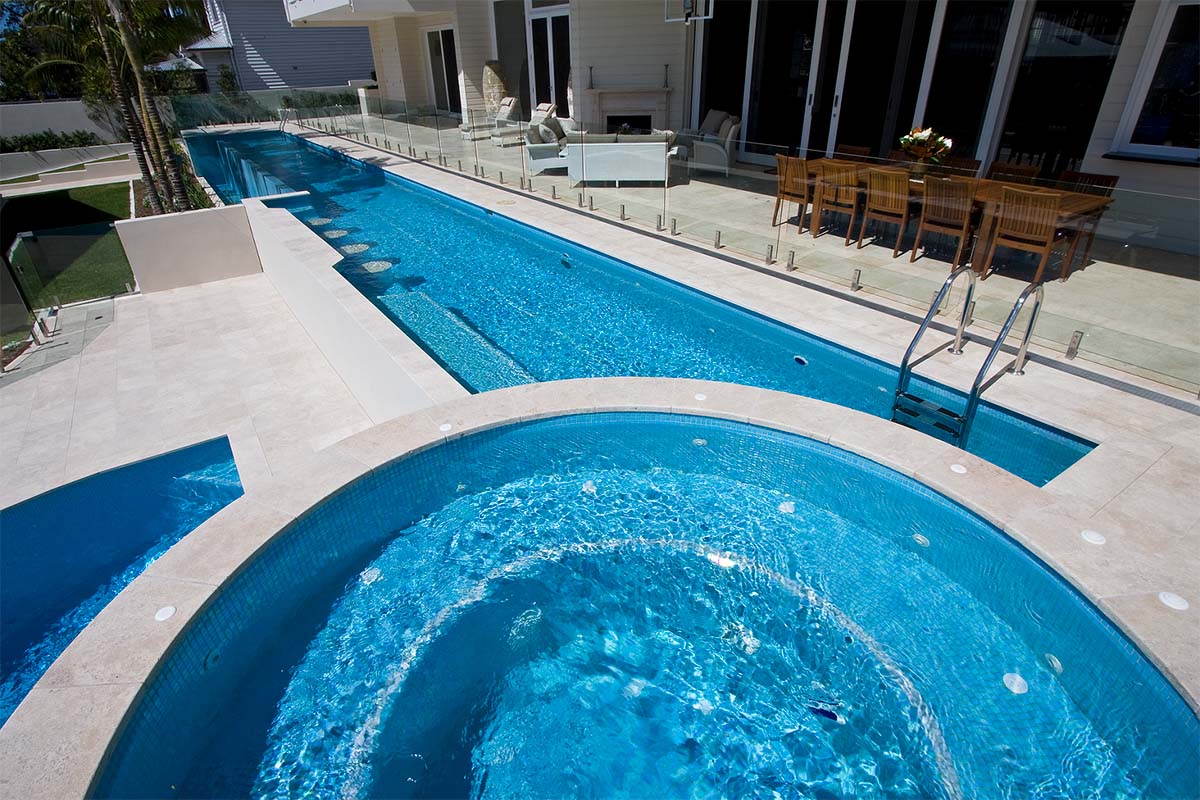 Macadamia Travertine pool coping and surrounds with fully tiled pool in Light Sky Blue Pearl