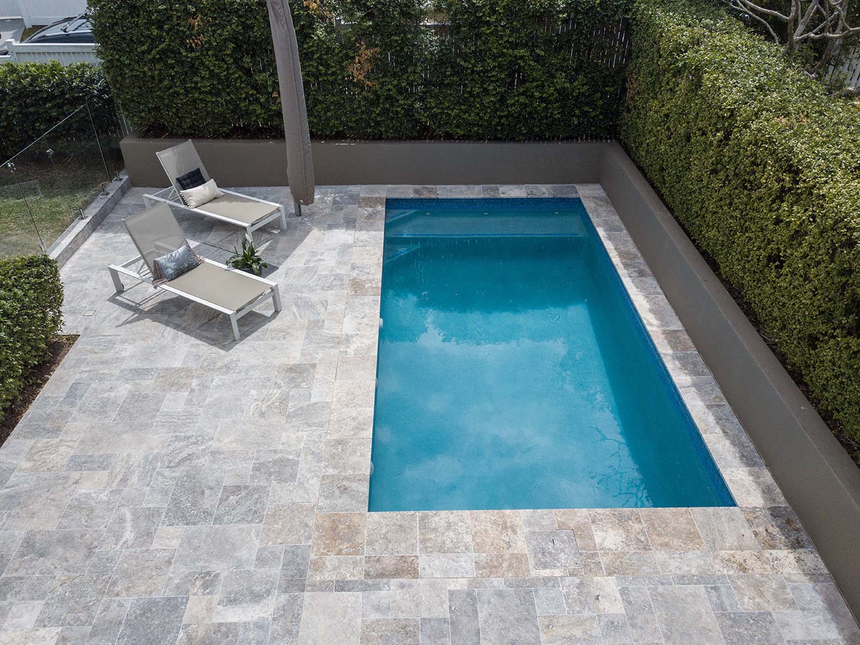 Silver Travertine pool coping and french pattern surrounds