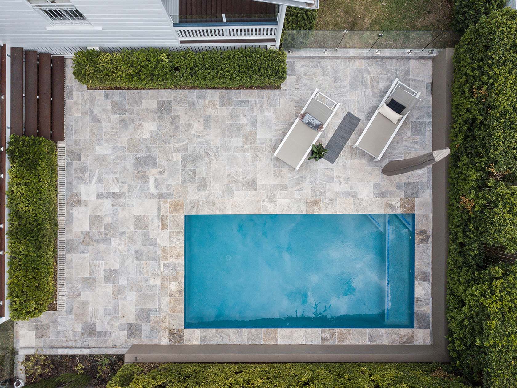 Silver Travertine pool coping and french pattern surrounds